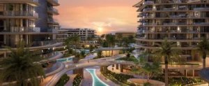 Sunset community view at The Meriva Collection by Ellington with illuminated pools, curved architecture and tropical landscaping in Dubai Presented by Tohid Fetrat