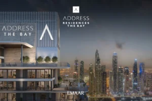 Address Residences The Bay at Emaar Beachfront by Emaar exterior tower view with illuminated Dubai skyline at night Presented by Tohid Fetrat