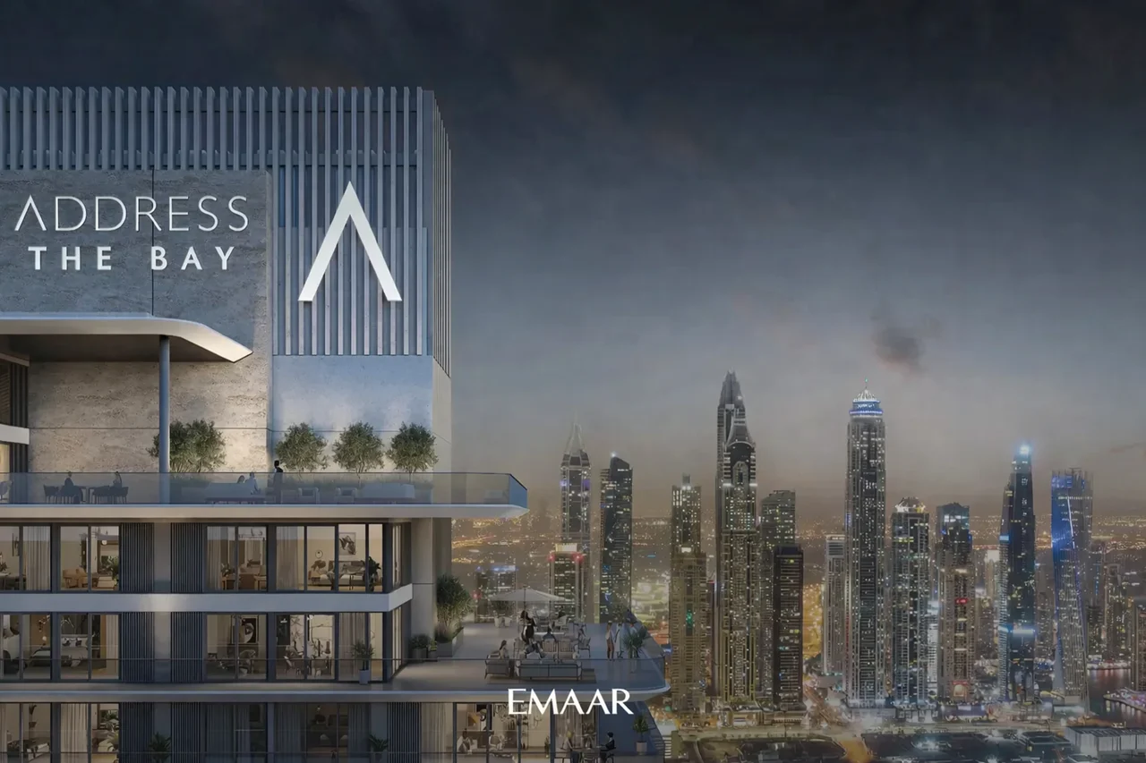 Address Residences The Bay at Emaar Beachfront by Emaar tower exterior with illuminated Dubai Marina skyline view at night Presented by Tohid Fetrat