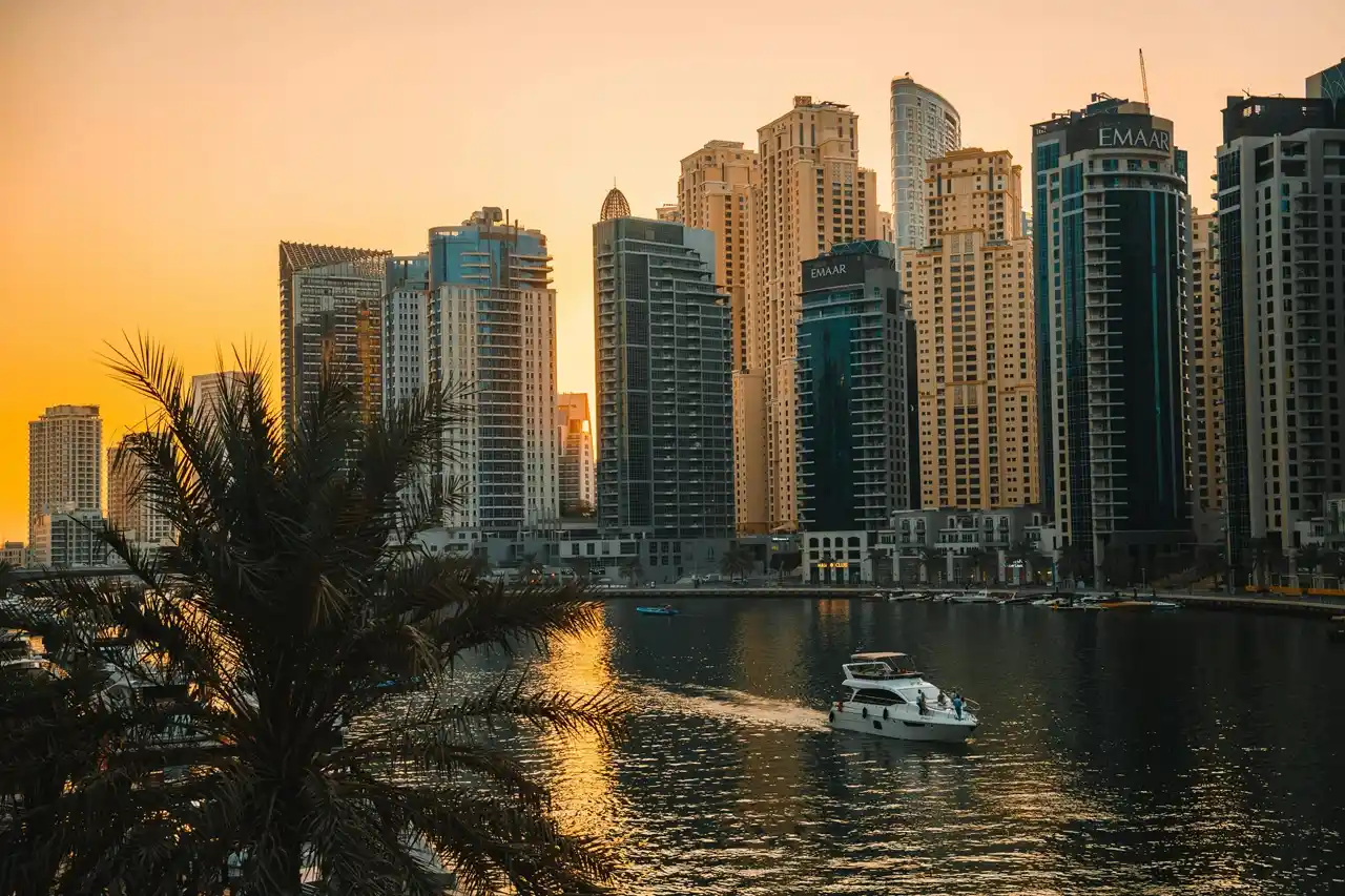 Airbnb property insurance exclusions concept with Dubai Marina waterfront at sunset and luxury towers highlighting limits of short term rental coverage Presented by Tohid Fetrat