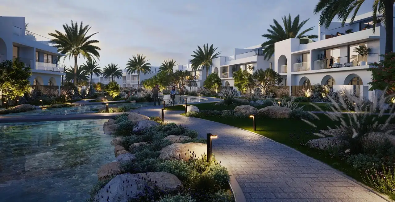 Alana at The Valley by Emaar landscaped lagoon walkway with lighting palm trees and modern villas at evening in Dubai - Presented by Tohid Fetrat