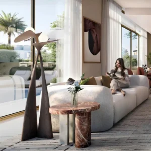 Avelia at The Valley by Emaar living room interior with modern furniture and floor to ceiling windows overlooking pool in Dubai - Presented by Tohid Fetrat