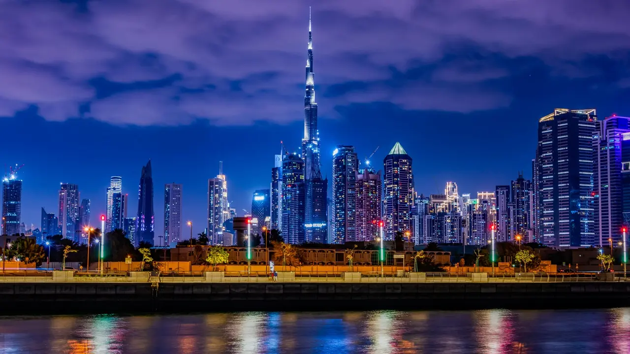 Downtown Dubai skyline with Burj Khalifa at night representing Dubai Property Handover and luxury real estate ownership in Dubai Presented by Tohid Fetrat