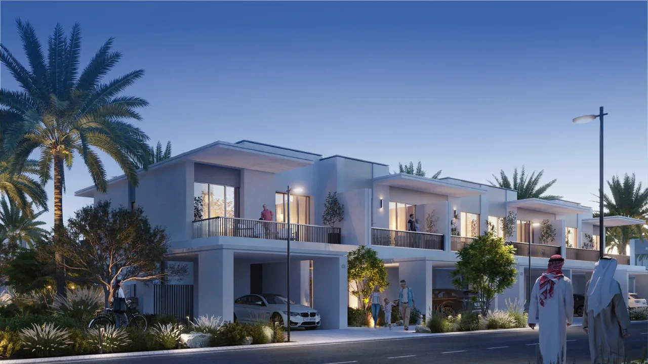 Modern townhouse residences with balconies and landscaped street views at Elora at The Valley in Dubai during evening ambiance Presented by Tohid Fetrat
