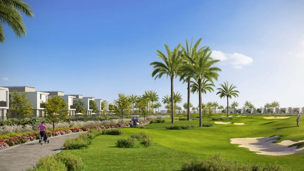 Luxury villas overlooking a manicured golf course with palm lined fairways and landscaped walking paths at Emaar South Dubai Presented by Tohid Fetrat