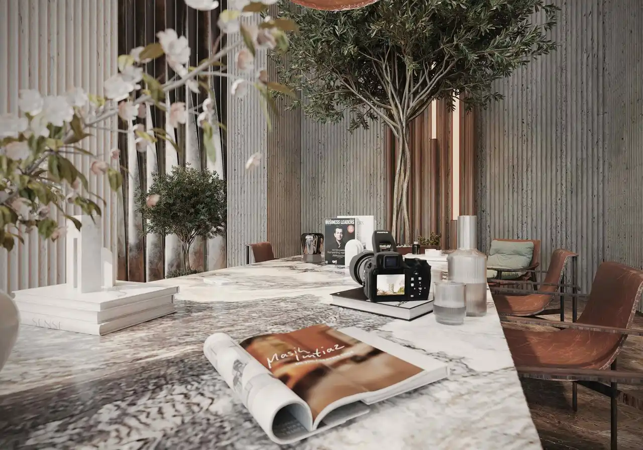 marble table with decor books camera and seating in luxury lobby at Sunset Bay Grand by Imtiaz Dubai Islands Presented by Tohid Fetrat
