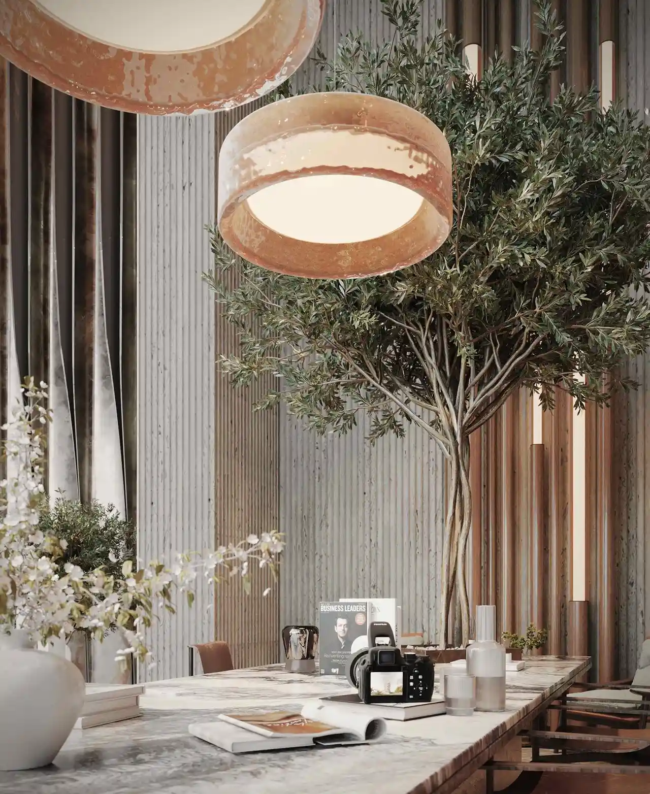 close up of pendant lights above marble table with decor and greenery at Sunset Bay Grand by Imtiaz Dubai Islands Presented by Tohid Fetrat