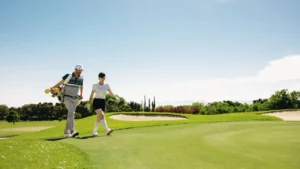 Vista Ridge at Emaar South by Emaar Properties golf course landscape with players walking across green fairways in Dubai - Presented by Tohid Fetrat
