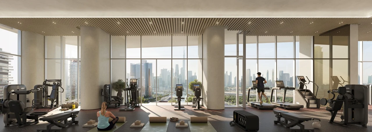 Artistry Two Residences by Select Group gym fitness area with modern equipment and floor to ceiling windows overlooking Dubai skyline in Dubai - Presented by Tohid Fetrat