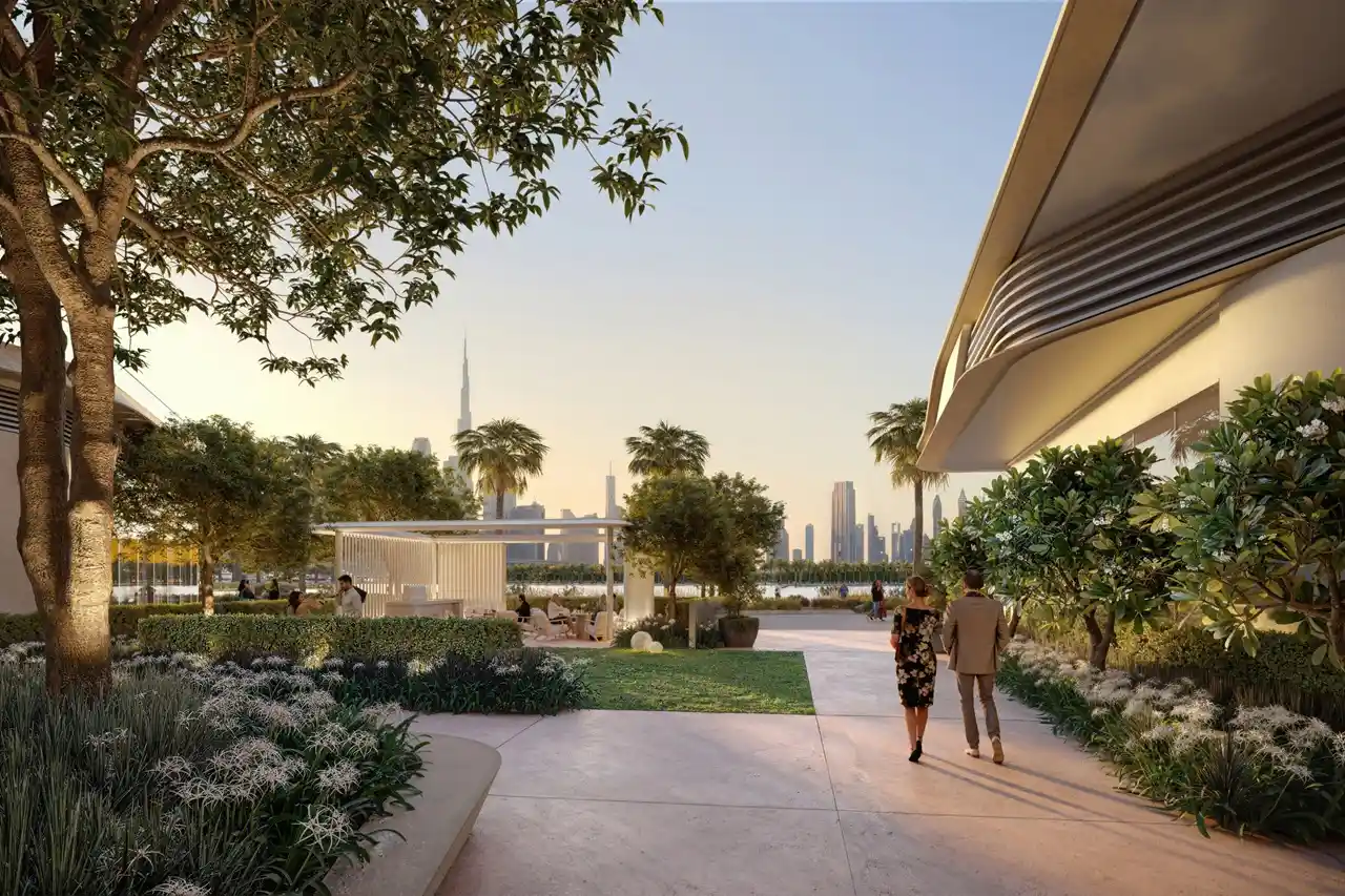 Artistry Two Residences by Select Group landscaped garden walkway with palm trees seating areas and Dubai skyline view in Dubai - Presented by Tohid Fetrat