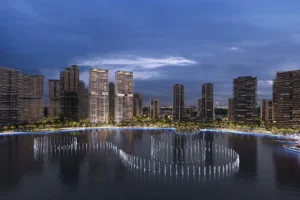 Artistry Two Residences by Select Group waterfront community night view with illuminated towers and fountain display in Dubai - Presented by Tohid Fetrat