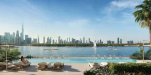 Artistry Two Residences by Select Group waterfront pool with lounge seating and Dubai skyline view across the water in Dubai - Presented by Tohid Fetrat