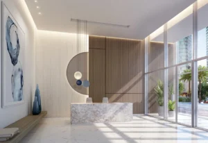 Beach Isle at Emaar Beachfront by Emaar reception lobby with marble desk modern lighting and floor to ceiling windows in Dubai - Presented by Tohid Fetrat