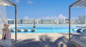 Beachgate by Address at Emaar Beachfront by Emaar infinity pool with sun loungers and open sea view deck in Dubai - Presented by Tohid Fetrat