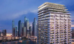 Beachgate by Address at Emaar Beachfront by Emaar illuminated tower at night with marina skyline and waterfront views in Dubai - Presented by Tohid Fetrat