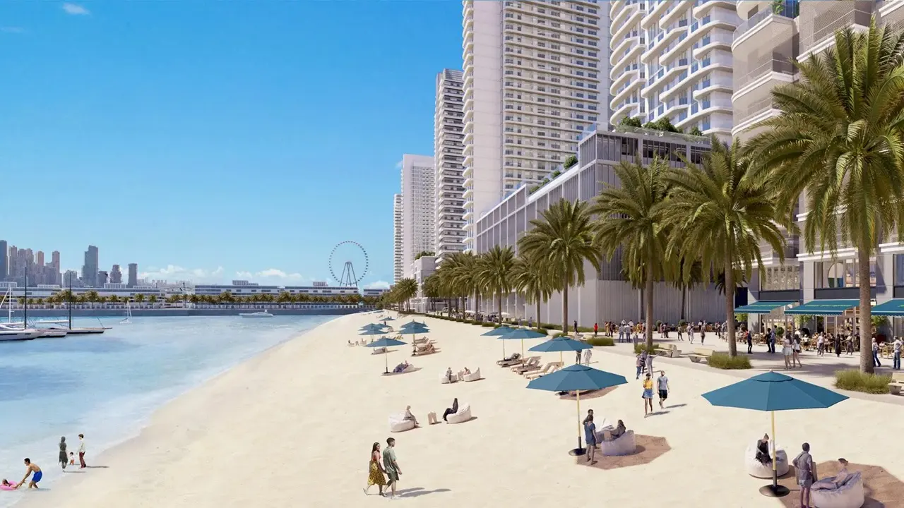 Beachgate by Address at Emaar Beachfront by Emaar private sandy beach with palm lined promenade sun umbrellas and waterfront skyline in Dubai - Presented by Tohid Fetrat