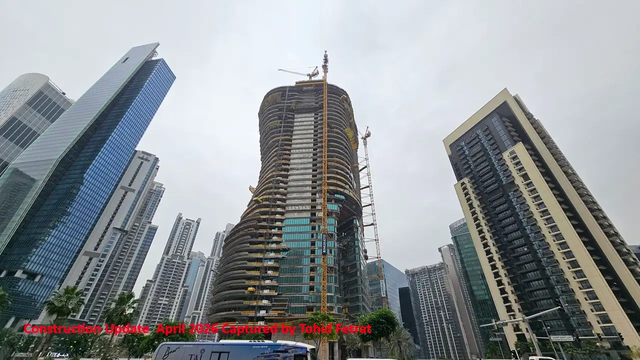 Bugatti by Binghatti construction update in April 2026 showing colorful visual marketing display panel with vibrant graphics and illuminated elements in Dubai - Captured by Tohid Fetrat