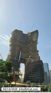 Bugatti by Binghatti construction update in April 2026 showing curved twin tower structure with cranes and facade progress in Dubai - Captured by Tohid Fetrat