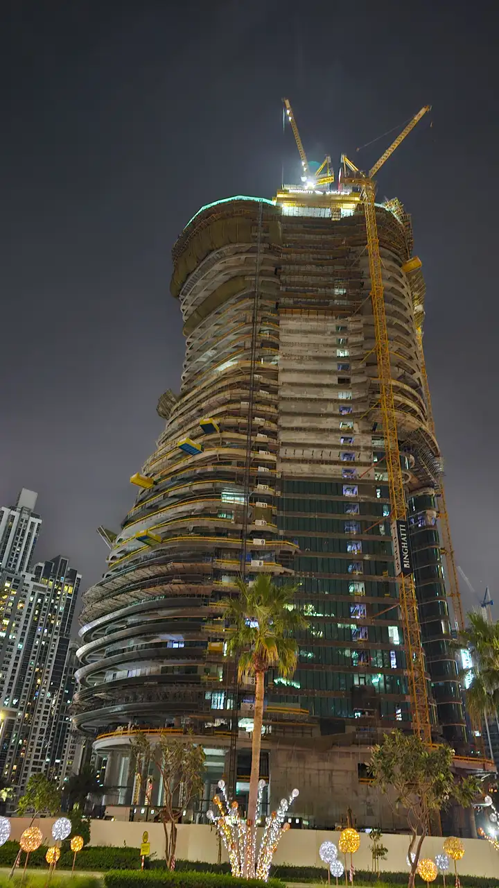 Bugatti by Binghatti construction update in January 2026 showing illuminated tower structure with cranes and ongoing night construction activity in Dubai - Captured by Tohid Fetrat