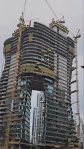 Bugatti by Binghatti construction update in January 2026 showing twin tower structure with elevated connecting section and cranes in Dubai - Captured by Tohid Fetrat