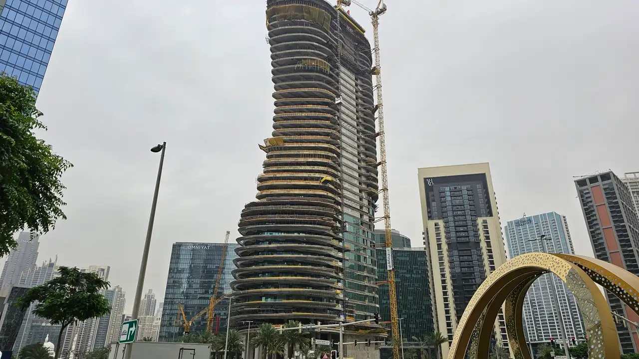 Bugatti Residences construction update showing structural progress with cranes and tower development in Business Bay Dubai Presented by Tohid Fetrat
