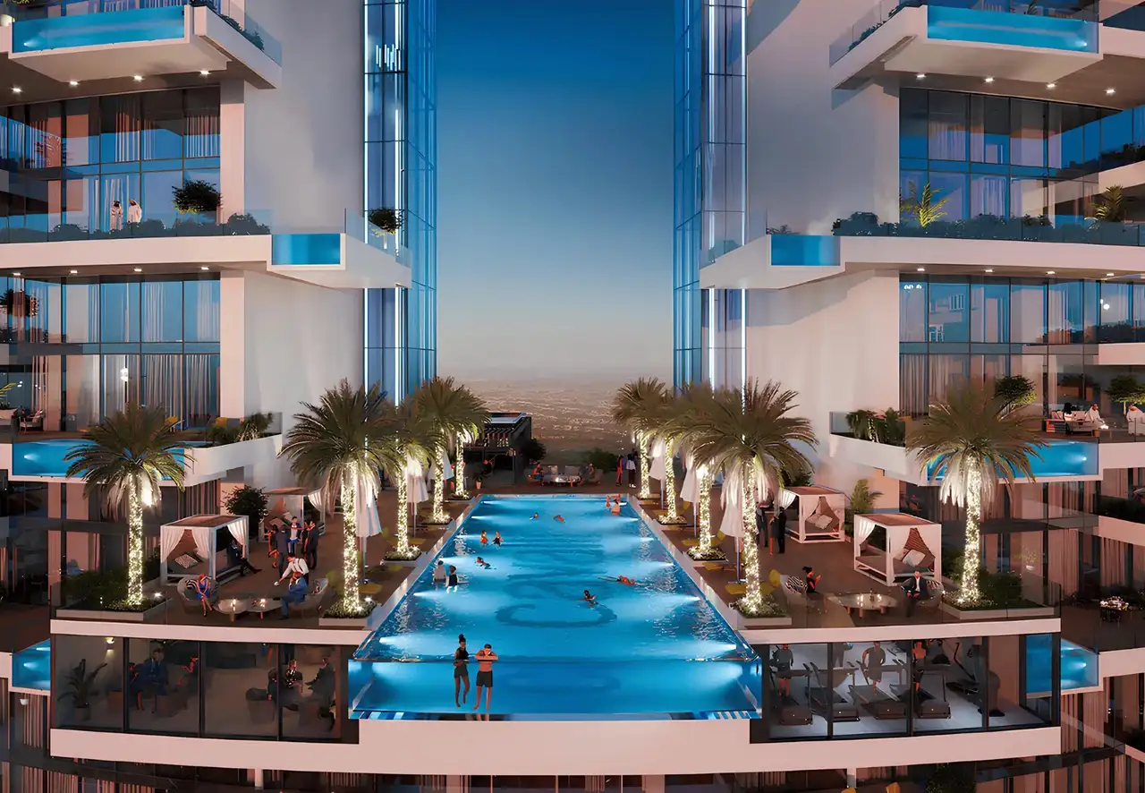 Cavalli Tower by DAMAC elevated sky pool with palm trees cabanas and evening lighting in Dubai - Presented by Tohid Fetrat