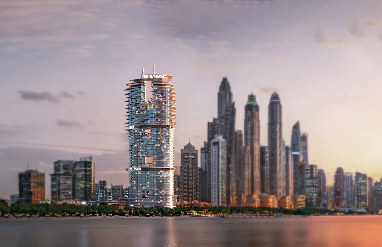 Cavalli Tower by DAMAC waterfront skyline view at sunset with illuminated facade in Dubai - Presented by Tohid Fetrat