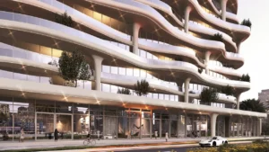 Coralis Grand Residences at Azizi Riviera Meydan building facade with curved balconies and ground level retail frontage in Dubai Presented by Tohid Fetrat