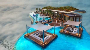 DAMAC Bay by Cavalli rooftop infinity pool with floating lounge decks cabanas and greenery above the towers in Dubai - Presented by Tohid Fetrat