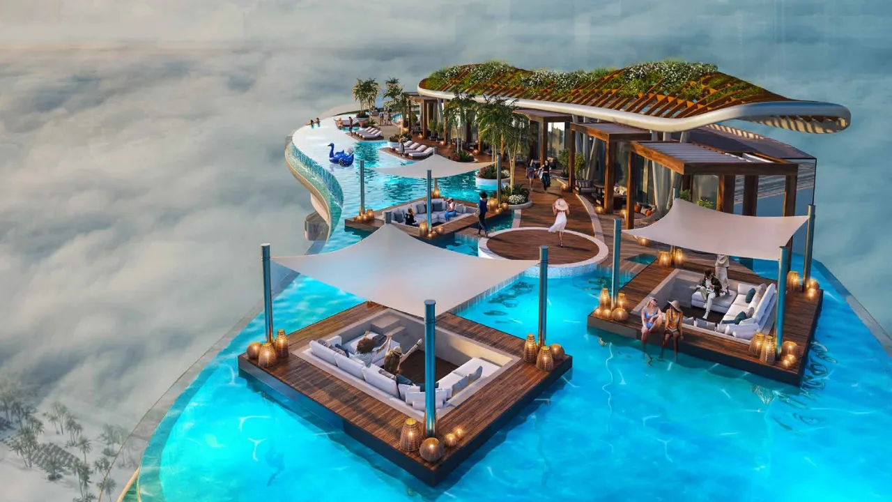 DAMAC Bay by Cavalli rooftop infinity pool with floating lounge decks cabanas and greenery above the towers in Dubai - Presented by Tohid Fetrat