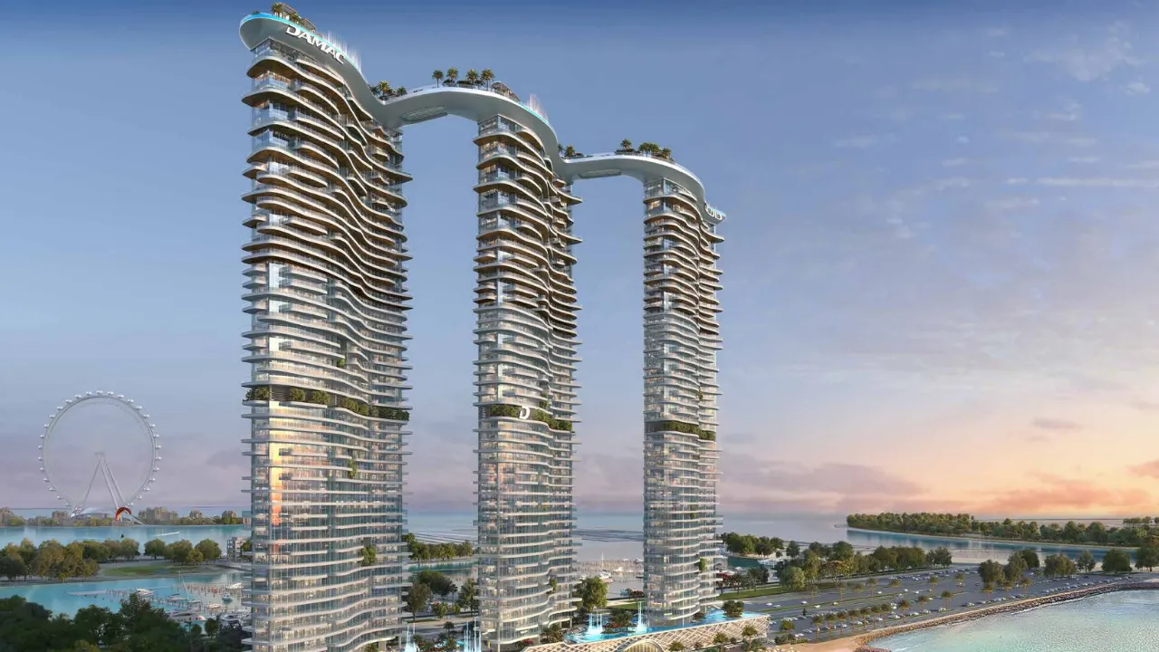 DAMAC Bay by Cavalli waterfront towers with flowing balconies and sky bridge overlooking the Gulf at sunset in Dubai - Presented by Tohid Fetrat