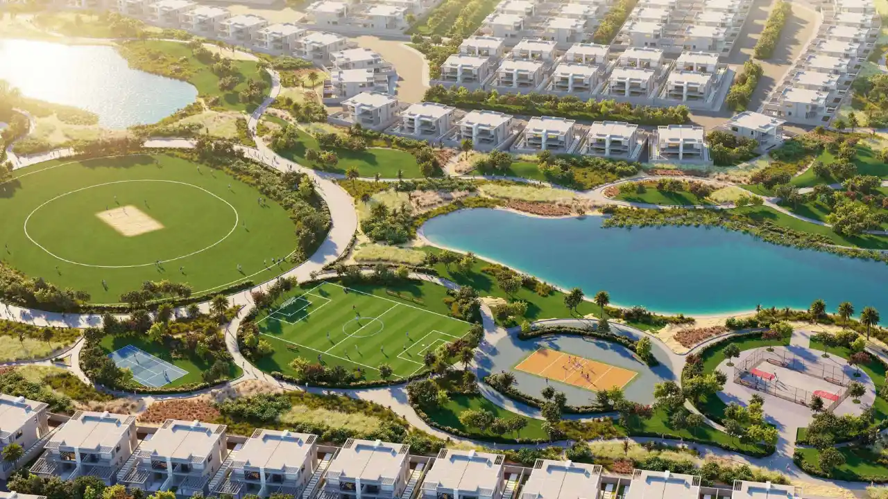 DAMAC Hills 2 by DAMAC Properties community park with football field tennis courts basketball courts landscaped pathways and residential villas in Dubai - Presented by Tohid Fetrat