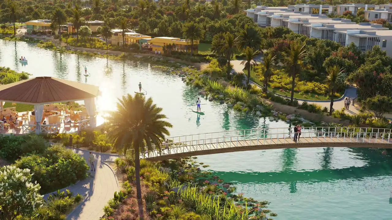 DAMAC Hills 2 by DAMAC Properties lagoon with pedestrian bridge water activities landscaped greenery and waterfront leisure spaces in Dubai - Presented by Tohid Fetrat