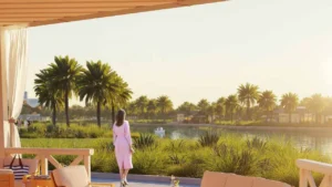 DAMAC Hills 2 by DAMAC Properties lagoon view with palm trees landscaped greenery and terrace seating area in Dubai - Presented by Tohid Fetrat