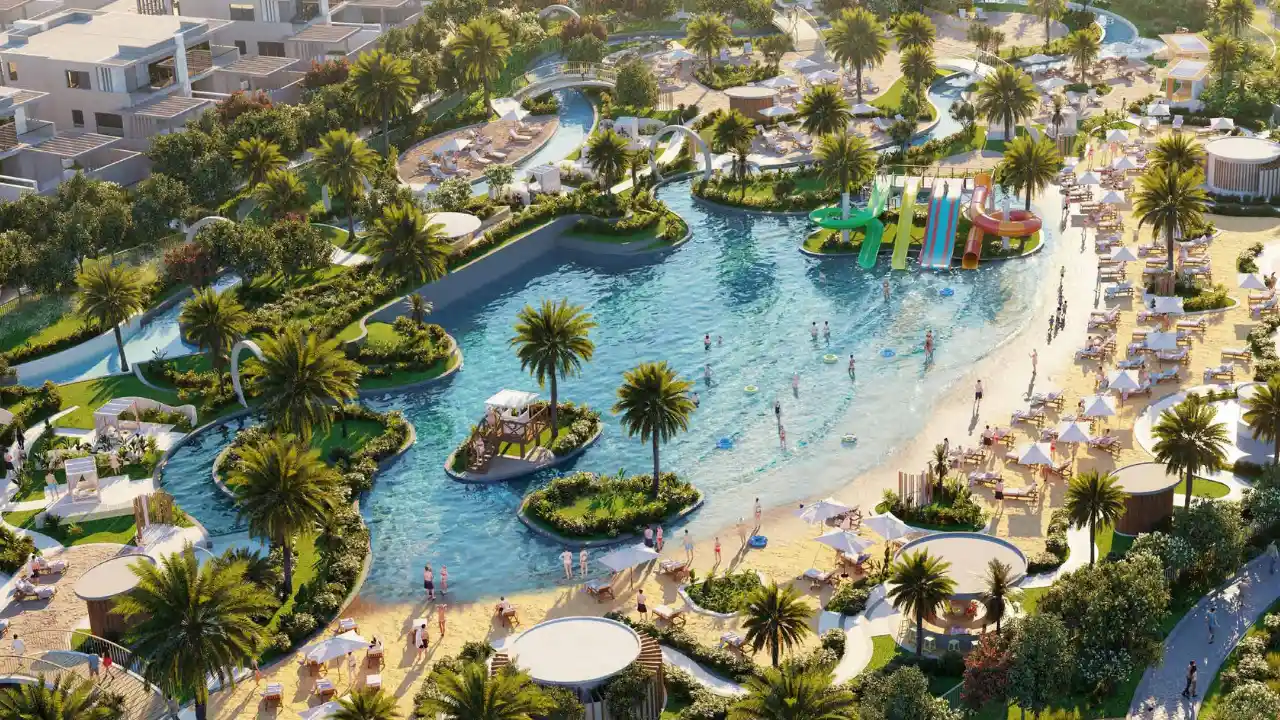DAMAC Hills 2 by DAMAC Properties lagoon waterpark with palm trees sandy beach slides and leisure areas in Dubai - Presented by Tohid Fetrat