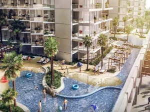DAMAC Hills 2 by DAMAC Properties residential building with lagoon style pool sandy edges palm trees and outdoor leisure spaces in Dubai - Presented by Tohid Fetrat