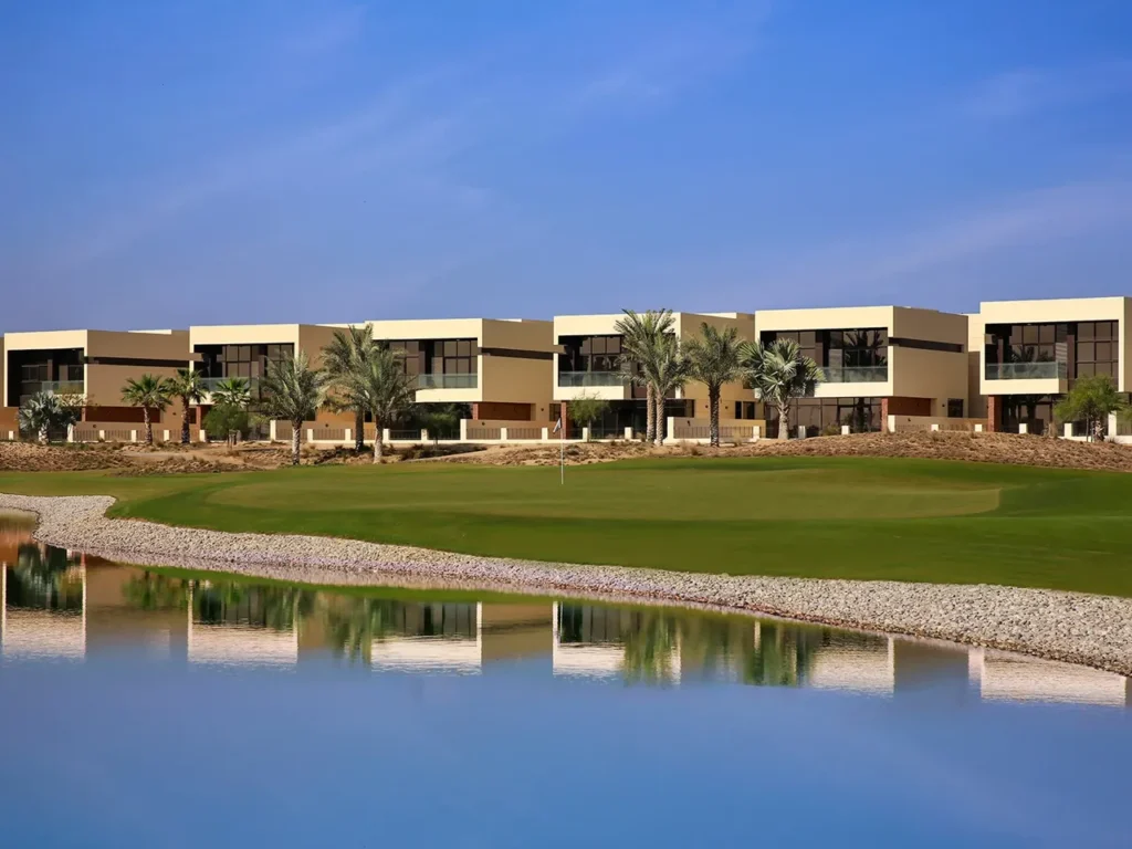 DAMAC Hills villas overlooking golf course with landscaped greens palm trees and water feature in Dubai Presented by Tohid Fetrat