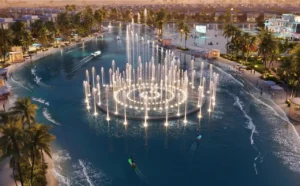 DAMAC Islands by DAMAC Properties illuminated lagoon fountain with waterfront villas and palm lined promenade at sunset in Dubai - Presented by Tohid Fetrat