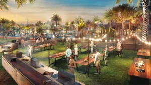 DAMAC Riverside by DAMAC Properties evening community barbecue area with outdoor dining tables festoon lighting and landscaped park setting in Dubai - Presented by Tohid Fetrat