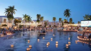 DAMAC Riverside by DAMAC Properties lagoon evening scene with floating seating decks outdoor cinema and illuminated waterfront villas in Dubai - Presented by Tohid Fetrat