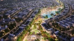 DAMAC Riverside by DAMAC Properties aerial masterplan with central lagoon landscaped parks and residential villas illuminated at night in Dubai - Presented by Tohid Fetrat