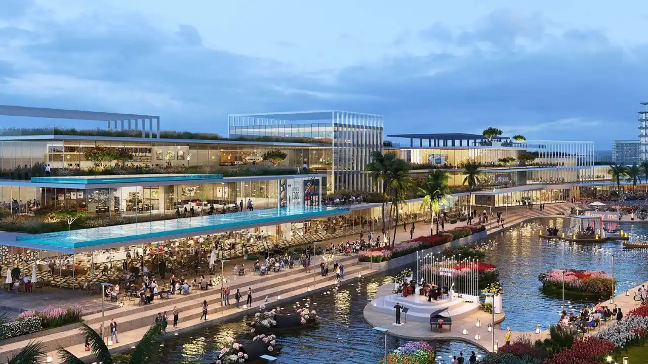 DAMAC Riverside by DAMAC Properties waterfront retail and dining promenade along canal with modern architecture and outdoor seating in Dubai - Presented by Tohid Fetrat