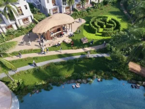 DAMAC Sun City by DAMAC Properties garden pavilion with outdoor seating landscaped pathways and waterfront greenery in Dubai - Presented by Tohid Fetrat