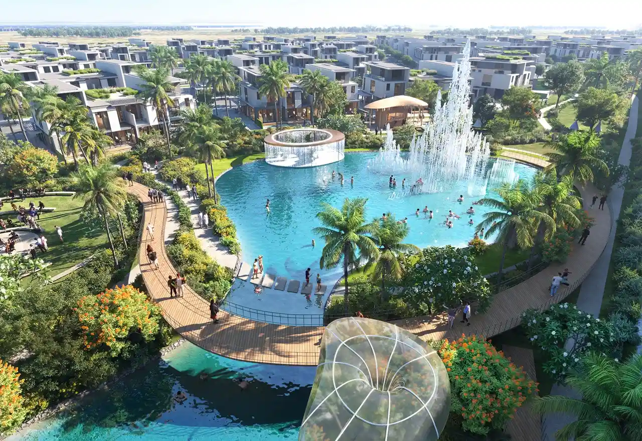 DAMAC Sun City by DAMAC Properties lagoon with fountain water feature landscaped walkways and surrounding villas in Dubai - Presented by Tohid Fetrat