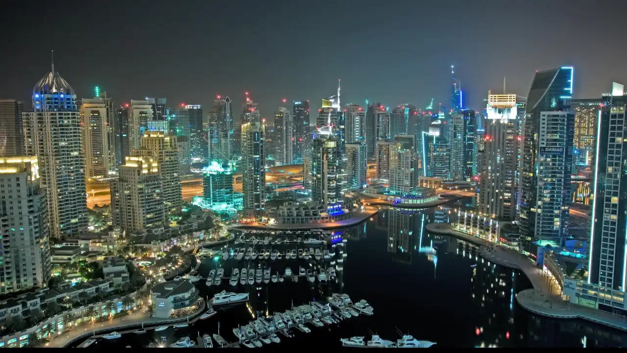 Dubai Marina skyline at night with waterfront towers representing Dubai Land Department guide and real estate governance in Dubai - Presented by Tohid Fetrat