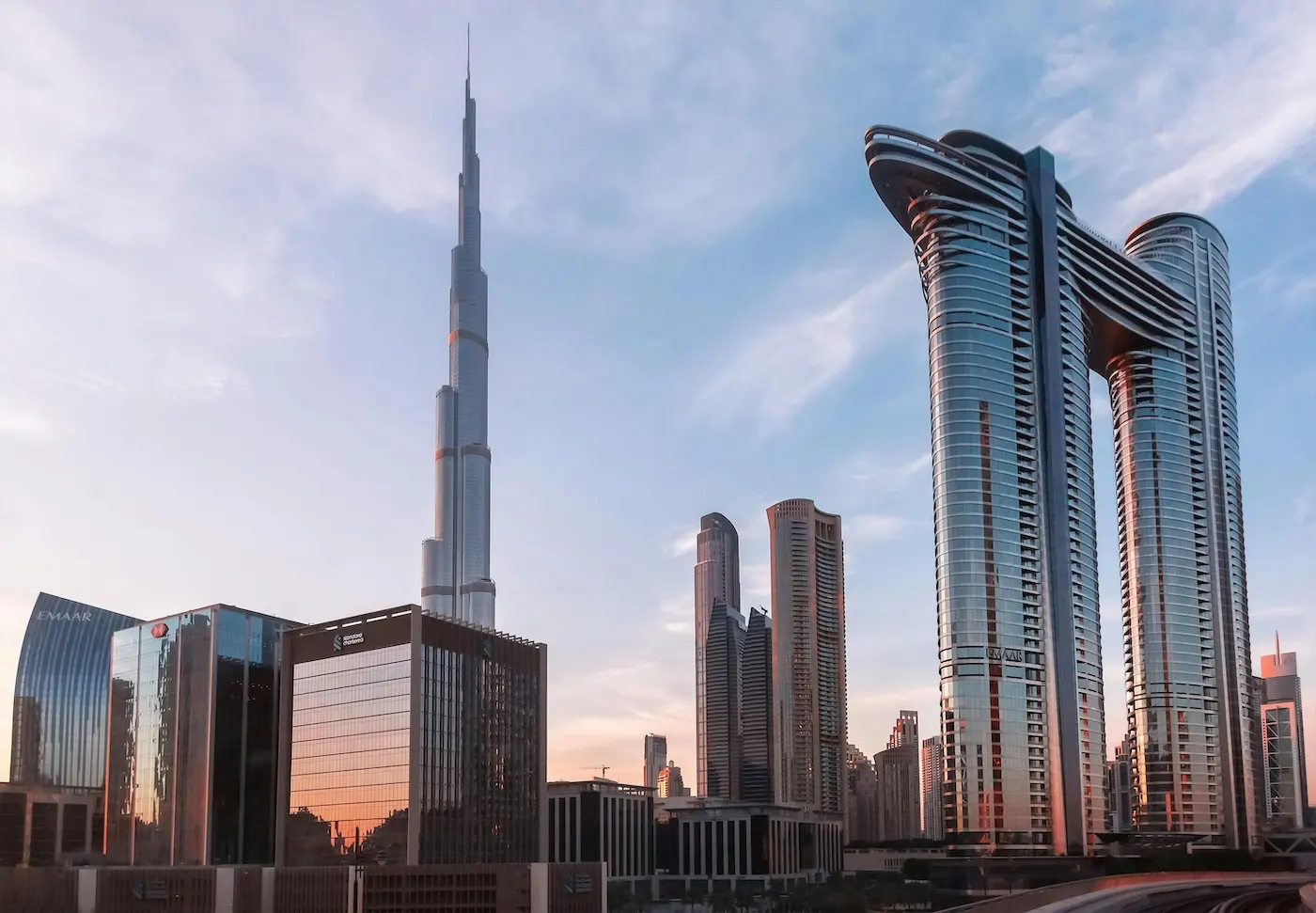 Dubai Real Estate Developers showcasing modern skyline with luxury towers and iconic architecture in Dubai at sunset Presented by Tohid Fetrat