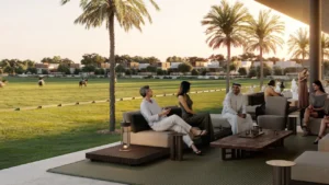 Equiterra at Grand Polo Club and Resort by Emaar open polo lounge with outdoor seating palm trees and field views in Dubai - Presented by Tohid Fetrat