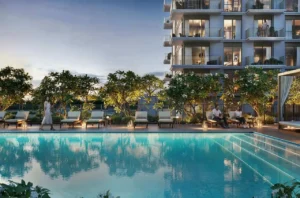 Golf Dale at Emaar South by Emaar outdoor swimming pool with sun loungers landscaped greenery and residential building in evening setting Dubai - Presented by Tohid Fetrat