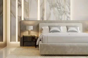 Grand Bleu Tower at Emaar Beachfront by Emaar elegant bedroom with upholstered bed marble wall panels and warm ambient lighting in Dubai - Presented by Tohid Fetrat