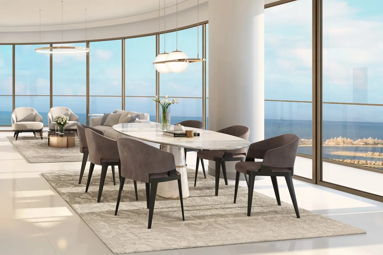 Grand Bleu Tower at Emaar Beachfront by Emaar open plan dining and living area with marble table modern seating and panoramic sea view in Dubai - Presented by Tohid Fetrat